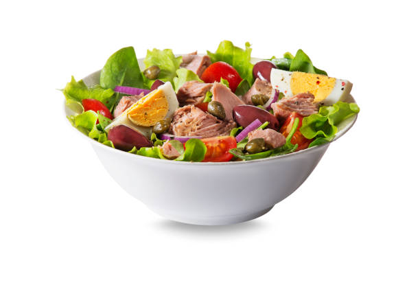Tuna salad Tuna salad with lettuce, eggs and tomatoes isolated on white background seafood salad stock pictures, royalty-free photos & images
