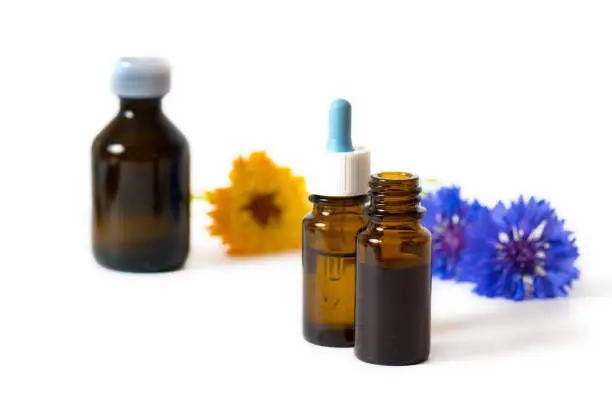 herbal essential oil in glass bottles isolated on white background