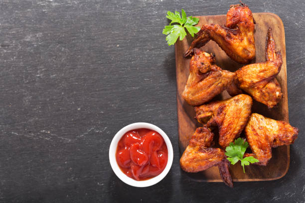 istock baked chicken wings on wooden board 953087946