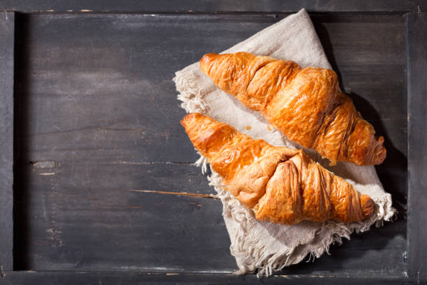 istock fresh croissants on wooden table 953087958