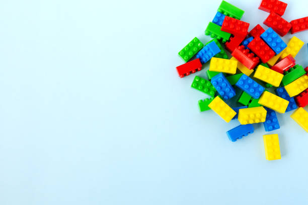 istock Colorful toy building blocks on blue background 953088302