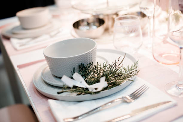 istock Table setting in white color, with decoration of green. Table setting for event party or wedding. Decor in green and white colors.Catering in restaurant. 953090844
