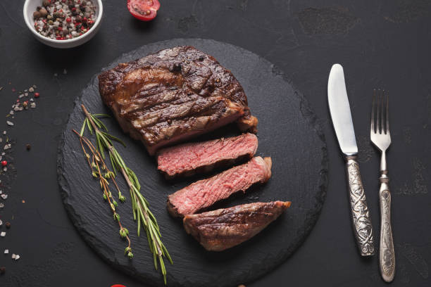 istock Rib eye steak and spices on black background 953091872