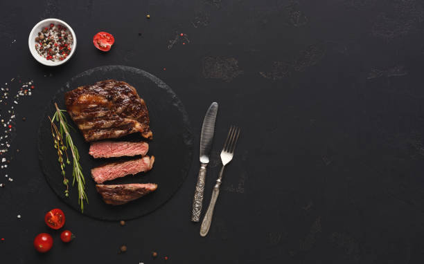 istock Rib eye steak and spices on black background 953092030