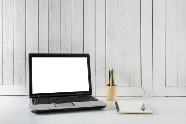istock workplace background with Blank white screen modern laptop computer. White wooden vintage blackground 953096494