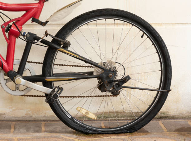 Macro view of a bicycle's gear and chain mechanism, showcasing split bicycle chain for a detailed maintenance, against a sunny background, emphasizing cycling lifestyle and outdoor activities