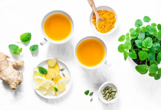 Turmeric, ginger anti-inflammatory green tea.  Healthy detox drink on light background, top view