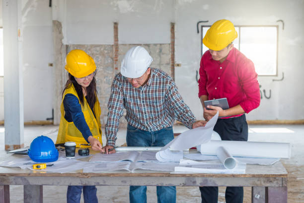 istock Group of engineer checking the blueprint with laptap and talking about construction project with commitment to success at construction site 953112536
