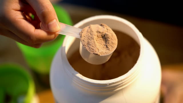 Three Shots of Man's Hand with Chocolate Whey Protein and Shaker