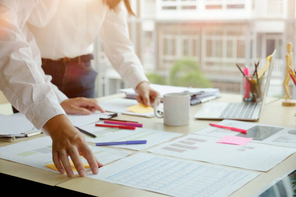 istock Young business colleagues  talking together while standing at a table in a modern office 953123118