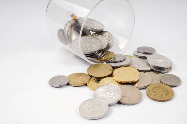 istock High Angle View Of Coins In Glass Container Over White Background 953126876