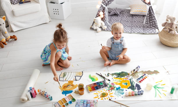 istock happy funny children paint with paint 953126910