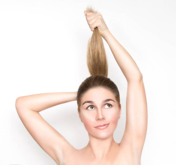 istock Beautiful blond woman pulls up her hair 953127800