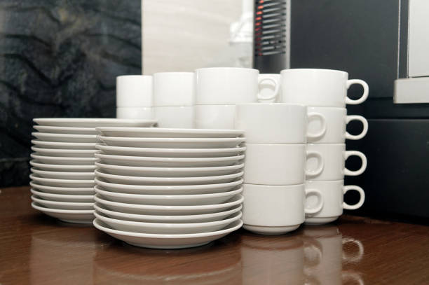 istock Stack of white coffee cup and dish plate ion wooden table in the kitchen 953128132