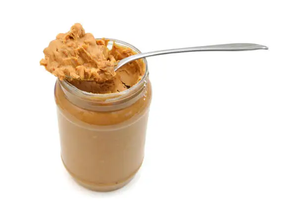 Peanut butter in jar with spoon