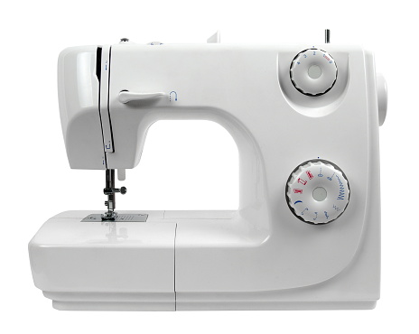 Primer plano de la máquina de coser sobre fondo blanco photo