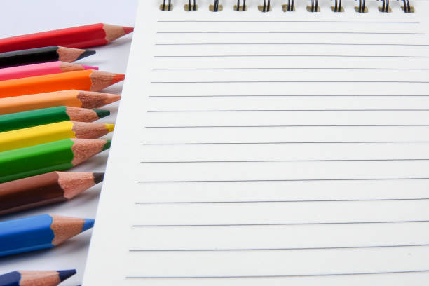 istock Directly Above Shot Of Colorful Pencils With Note Pad On Table 953136056