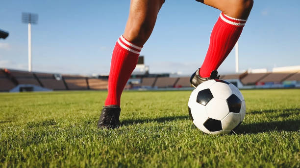 istock Low Section Of Man Playing Soccer At Stadium 953139388