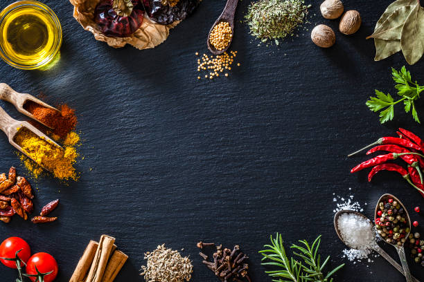 cooking nd seasoning spices border on black slate background - kitchen utensil ingredient cooking nobody imagens e fotografias de stock