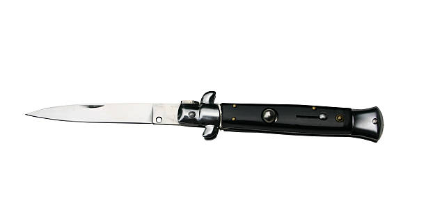 Black Switchblade knife Black Switchblade knife with clipping path switchblade stock pictures, royalty-free photos & images