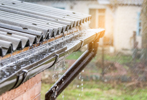 istock Rain pours on the roof. The sun breaks through 953149584