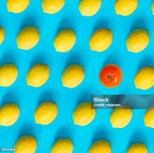 Lemons Pattern With Only One Mandarin Stock Photo - Download Image Now - Individuality, Art, Blue