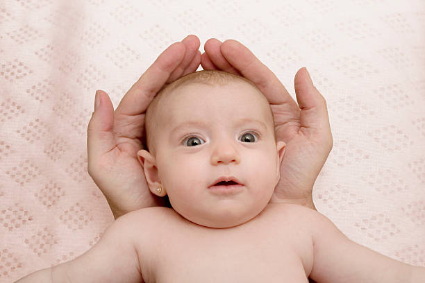 istock Baby protected in his father hands 95315106