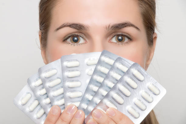 istock Beautiful laughing woman face and tablets in hand 953152662