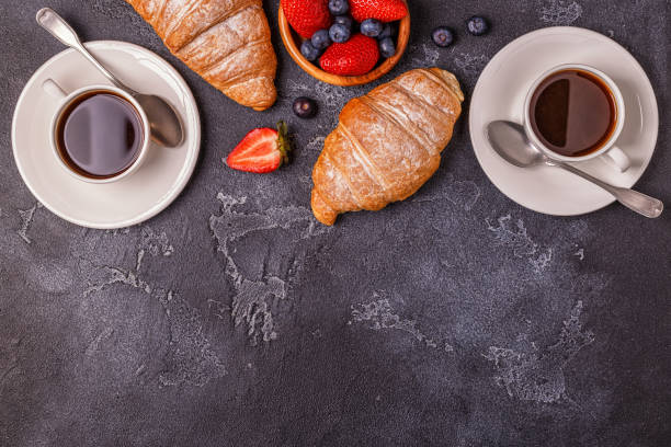 istock Breakfast with fresh croissants, orange juice and coffee, top view. 953153128
