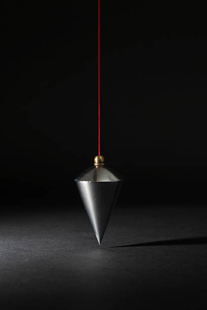 Vertical plumb on black Vertical plumb with red line on black background plumb line stock pictures, royalty-free photos & images