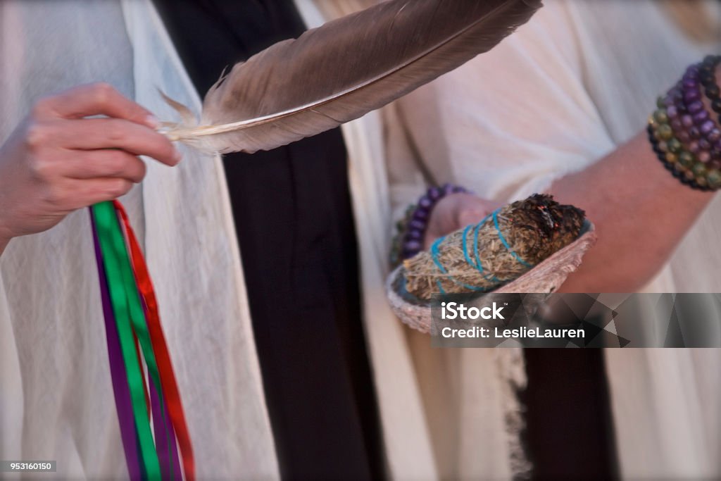 Smudging Smudging with women holding burning herbs and feather Sage Stock Photo