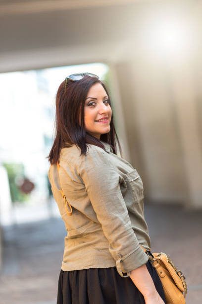 istock Portrait of happy pretty young brunette, light effect 953160236