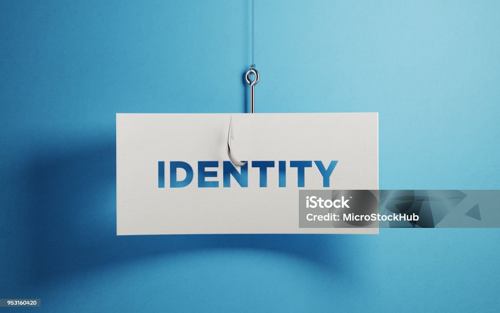 Identity Security And Phishing Concept White paper with identity text hooked by a fishing hook over blue background. Identity security and phishing concept. Horizontal composition with copy space. Identity Stock Photo