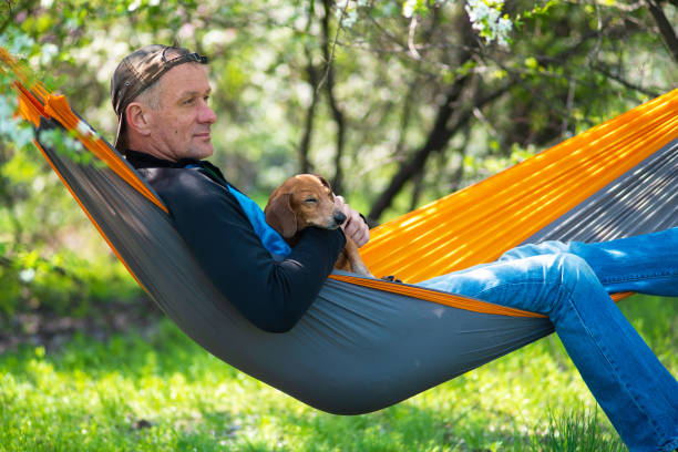 istock Dreaming man in a cap with his funny sleeping dog 953163884