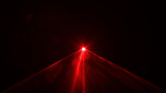 Red laser light on black background. Horizontal composition.