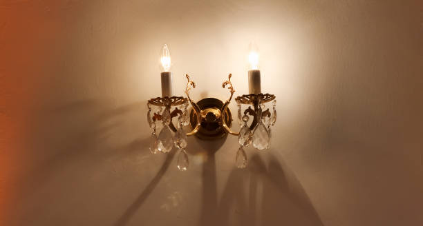 istock Candle-lit burning lamp on the wall 953164110