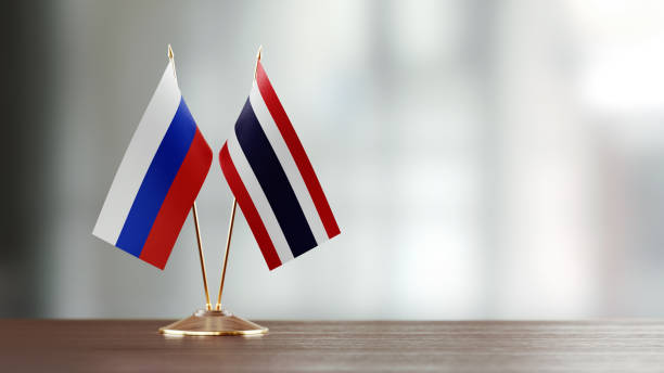 istock Russian And Thai Flag Pair On A Desk Over Defocused Background 953164546