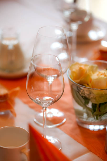 istock Glasses and plates on table in restaurant 953164664