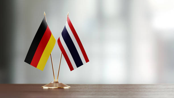 istock German And Thai Flag Pair On A Desk Over Defocused Background 953165108