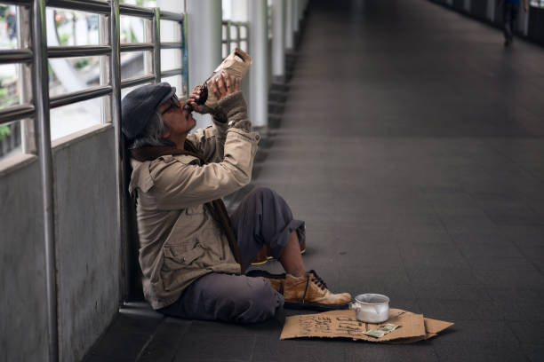 istock Sad Homeless old man drink beer 953167554