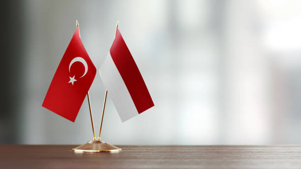 istock Turkish And Indonesian Flag Pair On A Desk Over Defocused Background 953168958