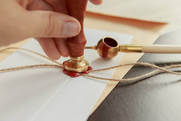 istock Notarial wax seal on tied scrolled documents, closeup 953172364