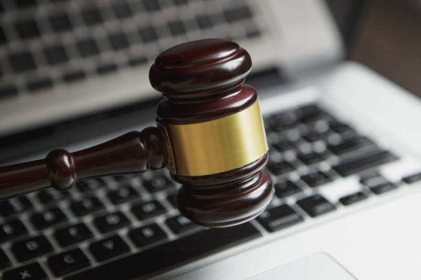 istock Wooden judge hammer on laptop computer white keyboard 953173240