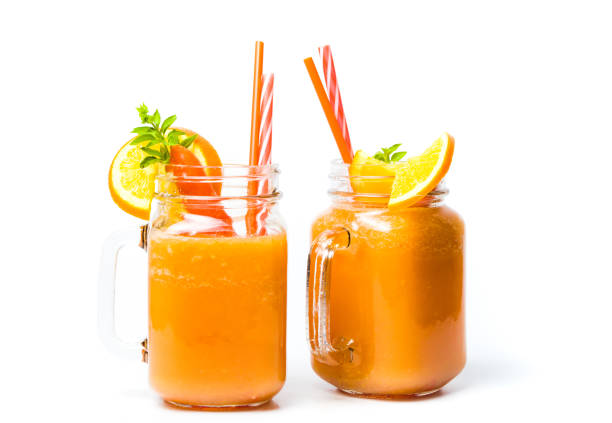 carrot smoothie in a jar isolated - orange smoothie imagens e fotografias de stock