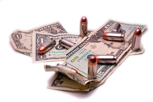 kugeln und rechnungen - currency crime gun conflict stock-fotos und bilder