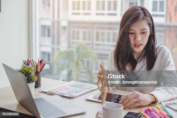 Young Woman Graphic Designer Working On Laptop And Computer In The Office Stock Photo - Download Image Now