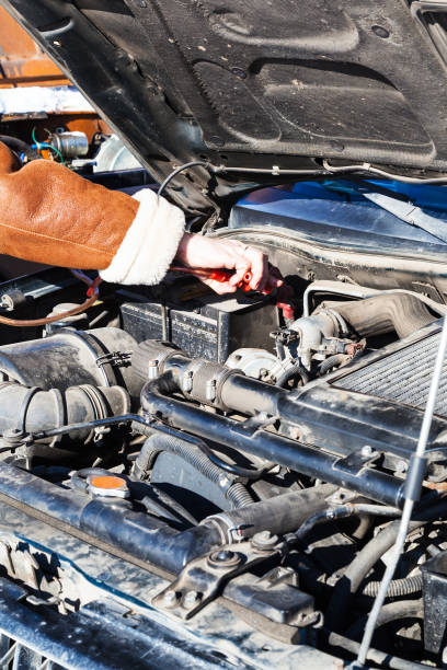 istock Jumpstart a dead car battery with another vehicle 953184580