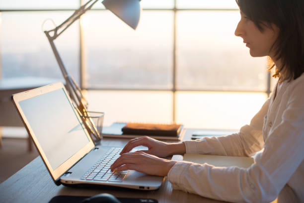istock Female teleworker texting using laptop and internet, working online. Freelancer typing at home office, workplace. 953193474