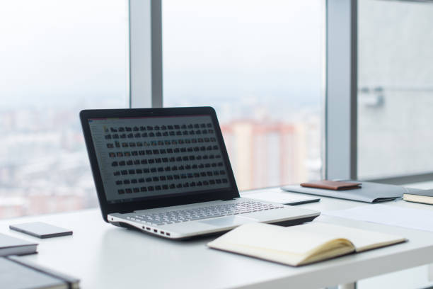 istock Workplace with notebook laptop Comfortable work table in office windows and city view. 953198638