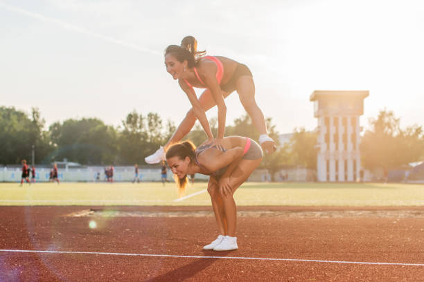 istock Fit women at the stadium playing leap frog. 953203076